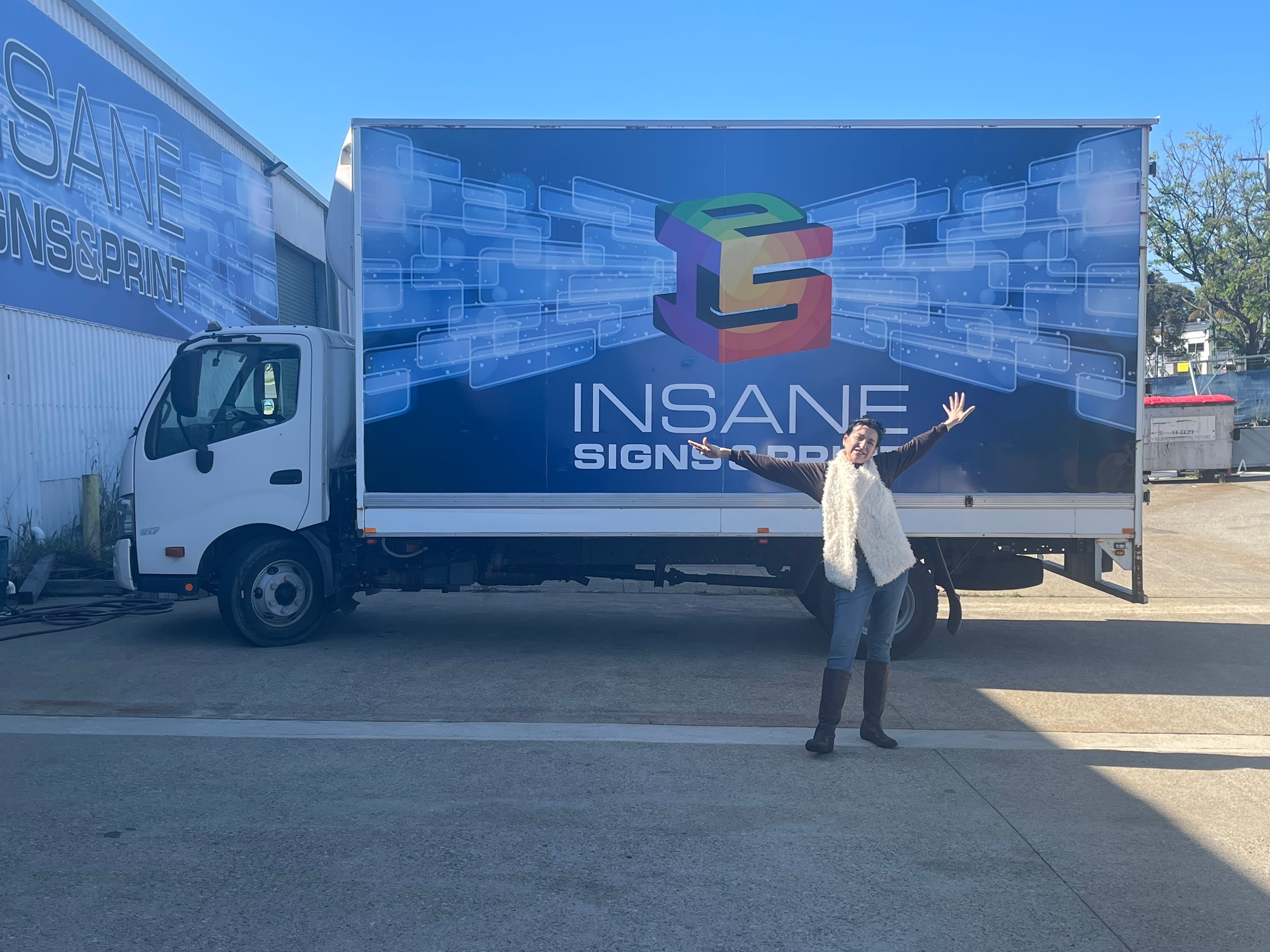 The Insane Signs & Print delivery truck, branded with the Insane Signs livery
